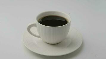 Black coffee in white cup isolated on white background with clipping path video