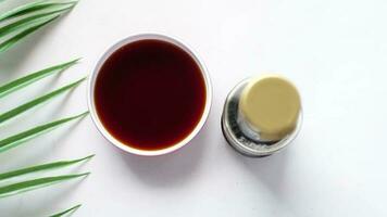 Top view of soy sauce in a container on white background video