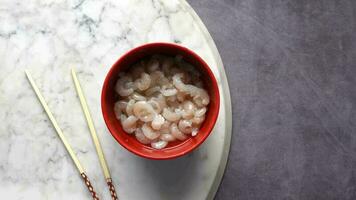 Small size raw king prawn in a bowl on table video