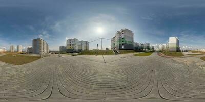 360 hdri panorama view with skyscrapers in new modern residential complex with high-rise buildings in town with overcast sky in equirectangular spherical projection, ready VR virtual reality content photo