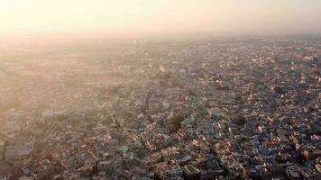 aéreo ver 4k vídeo por zumbido de azul ciudad pueblo en jodhpur, rajastán, India en amanecer. video