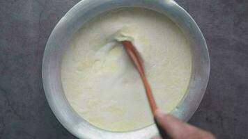 top view of stirring milk in a large container video