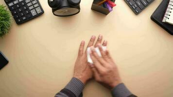 man disinfecting his hands with a wet wipe video