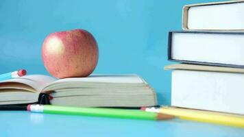 Back to school concept with apple on notepad on table video