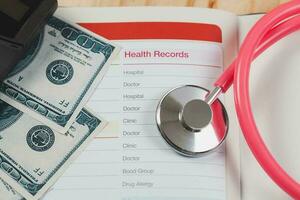 Health records in book note with fountain pen wooden background. photo