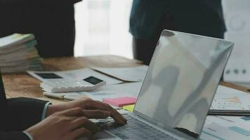 Financial analysts analyze business financial reports on a digital tablet planning investment project during a discussion at a meeting of corporate showing the results of their successful teamwork. video