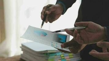 Financial analysts analyze business financial reports on a digital tablet planning investment project during a discussion at a meeting of corporate showing the results of their successful teamwork. video