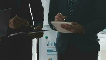 Financial analysts analyze business financial reports on a digital tablet planning investment project during a discussion at a meeting of corporate showing the results of their successful teamwork. video