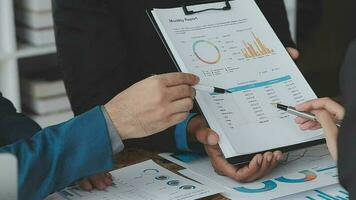 Financial analysts analyze business financial reports on a digital tablet planning investment project during a discussion at a meeting of corporate showing the results of their successful teamwork. video