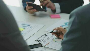 Financial analysts analyze business financial reports on a digital tablet planning investment project during a discussion at a meeting of corporate showing the results of their successful teamwork. video