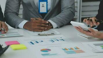 Financial analysts analyze business financial reports on a digital tablet planning investment project during a discussion at a meeting of corporate showing the results of their successful teamwork. video