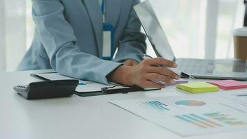 Financial analysts analyze business financial reports on a digital tablet planning investment project during a discussion at a meeting of corporate showing the results of their successful teamwork. video
