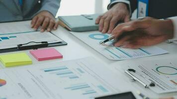 Financial analysts analyze business financial reports on a digital tablet planning investment project during a discussion at a meeting of corporate showing the results of their successful teamwork. video