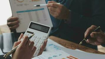 Financial analysts analyze business financial reports on a digital tablet planning investment project during a discussion at a meeting of corporate showing the results of their successful teamwork. video