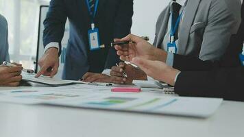 Financial analysts analyze business financial reports on a digital tablet planning investment project during a discussion at a meeting of corporate showing the results of their successful teamwork. video