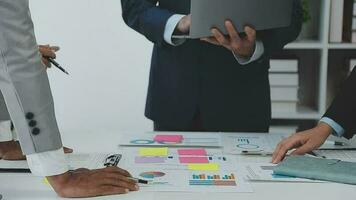 Financial analysts analyze business financial reports on a digital tablet planning investment project during a discussion at a meeting of corporate showing the results of their successful teamwork. video