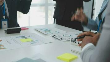 Financial analysts analyze business financial reports on a digital tablet planning investment project during a discussion at a meeting of corporate showing the results of their successful teamwork. video