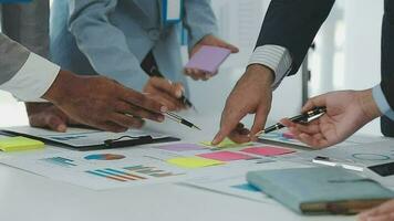 Financial analysts analyze business financial reports on a digital tablet planning investment project during a discussion at a meeting of corporate showing the results of their successful teamwork. video