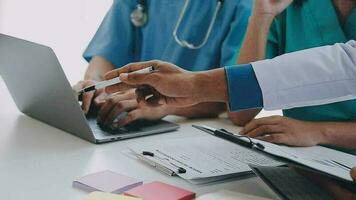 Concentrated medical team using laptop together in the office video