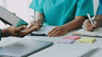 Concentrated medical team using laptop together in the office video