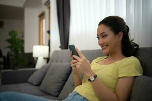 Woman using smart phone and Browsing Internet at home photo