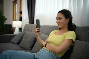 Woman using smart phone and Browsing Internet at home photo
