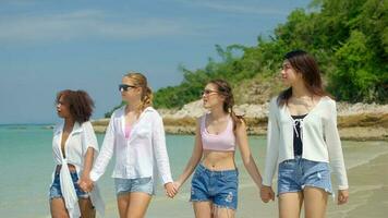 A group of teenage girls run and play at the beach for their summer vacation and they smile and enjoy their vacation. photo