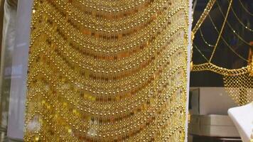 Dubai, UAE - 12th october, 2022 - most expensive shop items - luxury golden dresses and outfits for woman on shop display in gold souk in old Dubai video