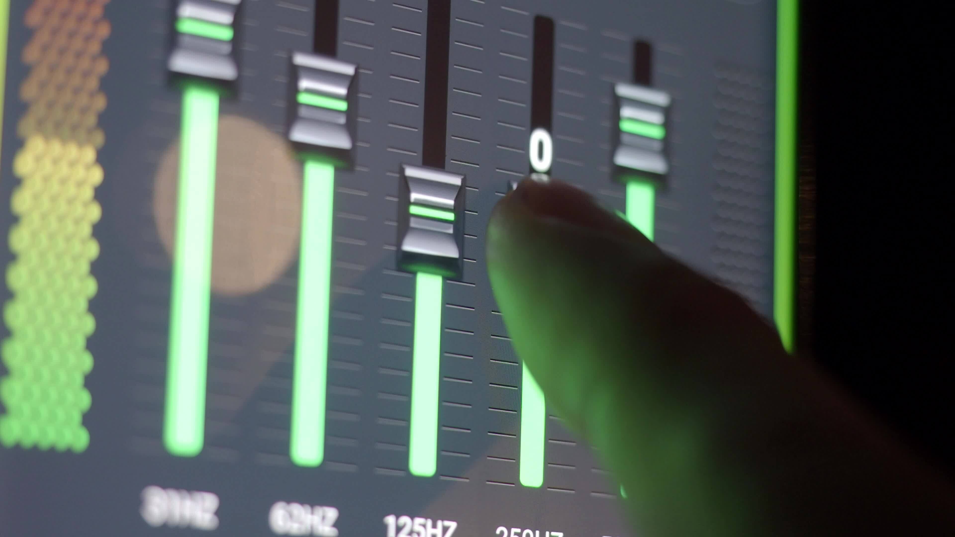 Hand tuning Sound Equalizer on digital screen. Digital music sound ...