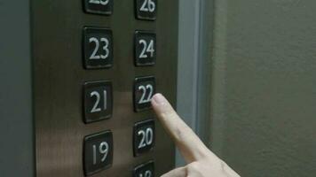 Hand pressing lift button up to high floor of office building or hotel condominium. video