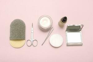 conjunto de personal cuidado accesorios, un espejo, un facial esponja, suero, tijeras, pinzas, algodón almohadillas, un tarro de crema foto