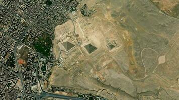 Satellite Cairo pyramids of Giza map background loop. Spinning around Egypt city air footage. Seamless panorama rotating over downtown backdrop. video