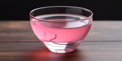 Small glass bowl with pink liquid photo