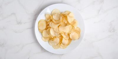 Delicious potato chips in a deep white plate photo