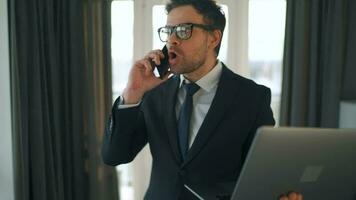 Caucasian Man Dressed in a Jacket and Underwear Using Laptop To Make a Video Call From Home