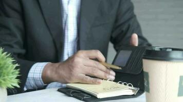 Thoughtful businessman turning pager of a diary video