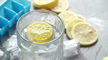 Refreshing lemon water drink on table, top view video