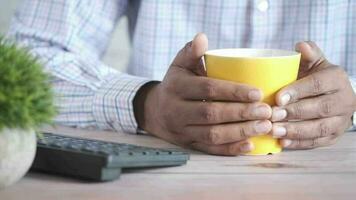 close up of man hand holding mug isolated on black video