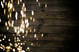 Golden bokeh lights with wooden background photo