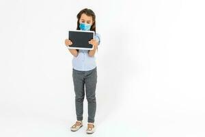 Masked child - protection against influenza virus. Little Caucasian girl wearing mask for protect pm2.5. baby on a gray background with copy space. epidemic, pandemic. photo