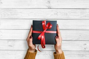 Christmas presents laid on a wooden table background photo