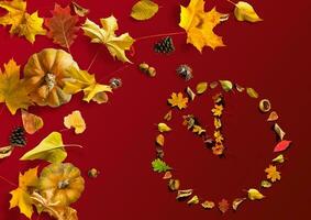 The watch dial from the leaves on a yellow background photo