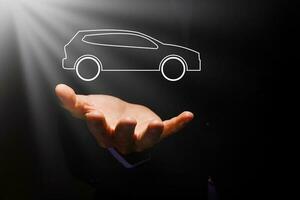 Hands protecting icon of car. view of hands showing gesture of protecting car. Car insurance and automotive business concept. photo