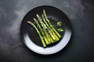 Traditionally grilled green asparagus with herbs as a top view on a modern design plate with copy space, generate ai photo