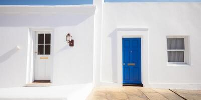 A small white house with yellow door photo