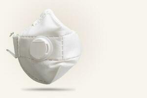 White n95 mask on gray background, n95 respirator with ventilation valve, anti-haze mask, photo