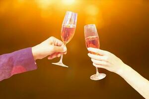 Two glasses of champagne with lights in the background. christmas background photo