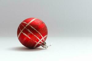 Single red Christmas tree ball decoration isolated over the white background, photo