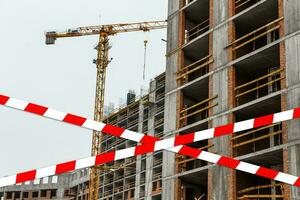 red and white safety tape at the construction site photo