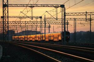 Rails illuminated by the setting sun photo